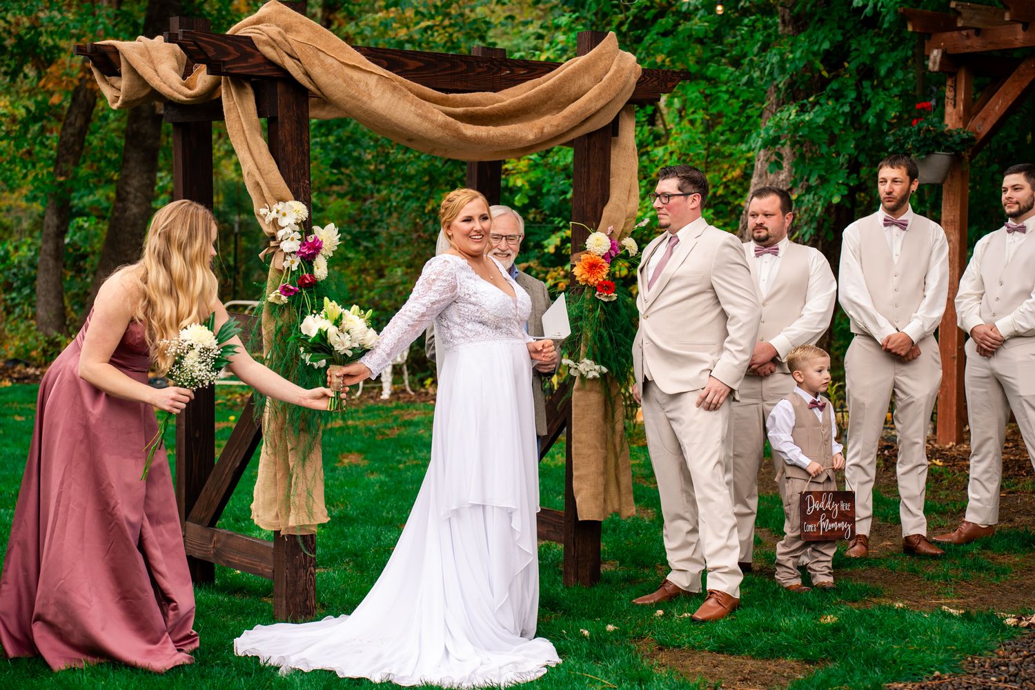 bride hands her bouquet to maid of honor