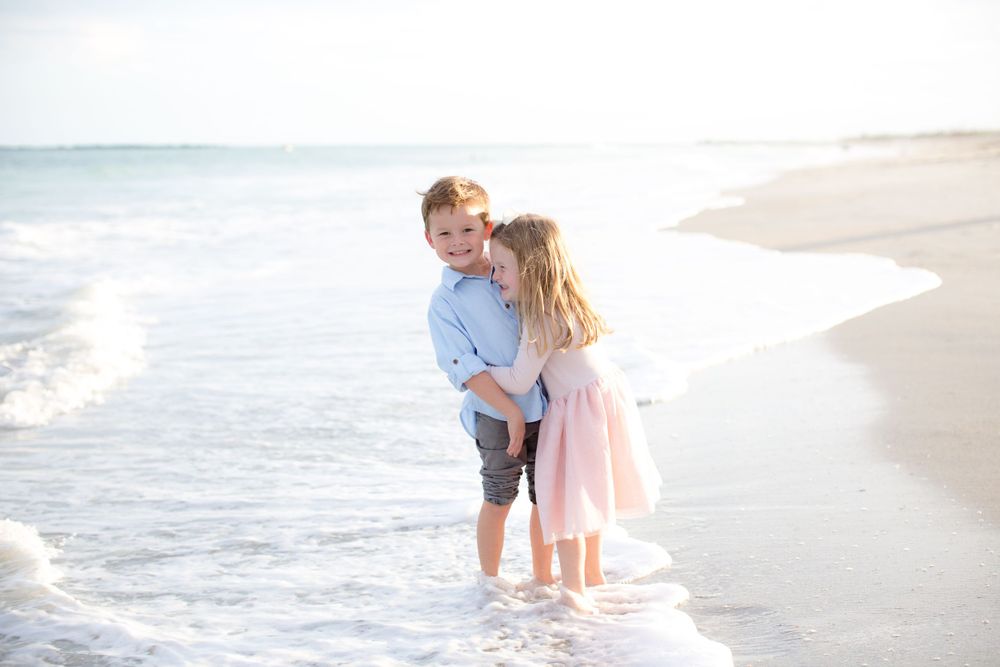Children playing and laughing together in the ocean surf.