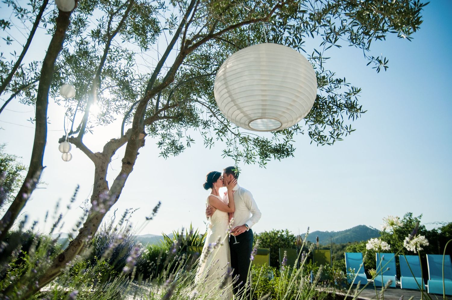 The newly married bride and groom kiss on their wedding day in Sitges, Barcelona, Spain.