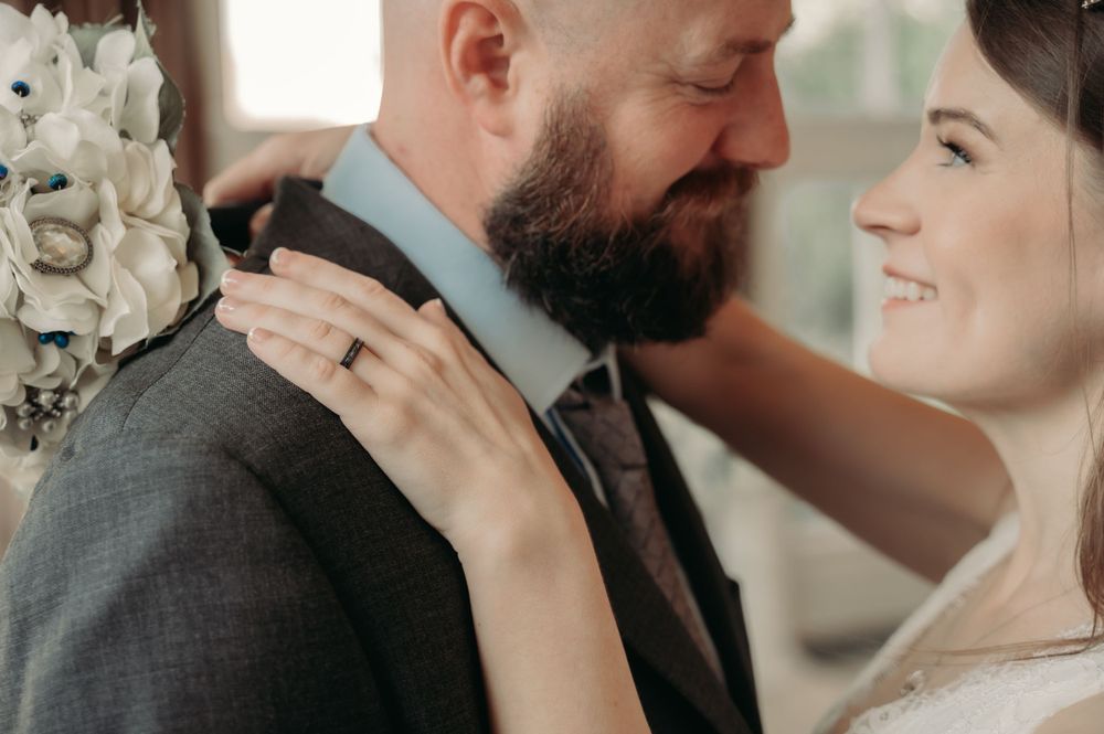 An intimate wedding portrait showing a tender moment between newlyweds.