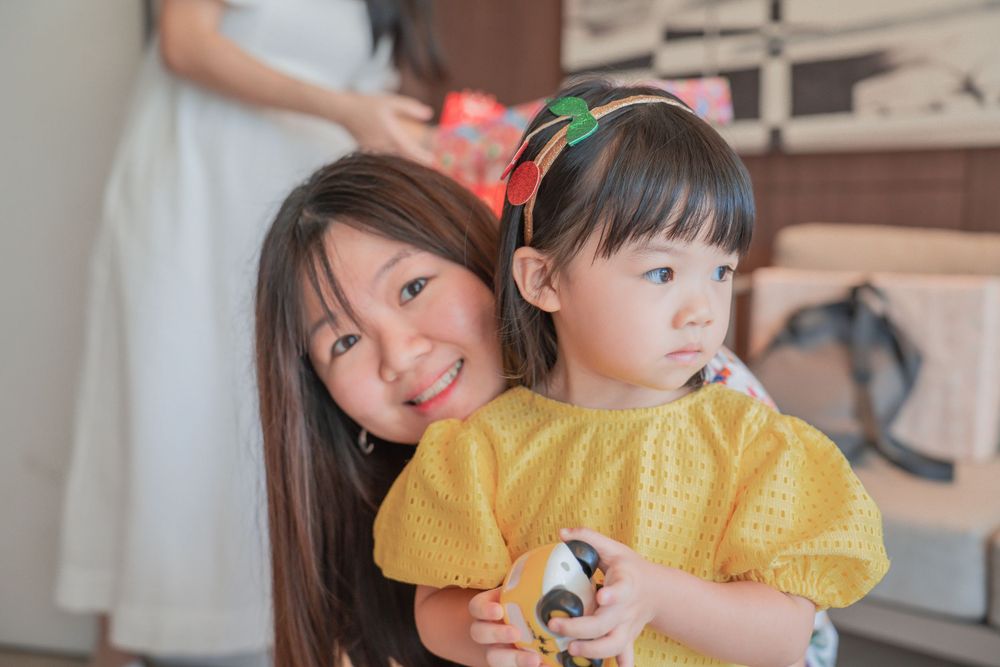 Bright yellow dress stands out against casual party setting during celebration.