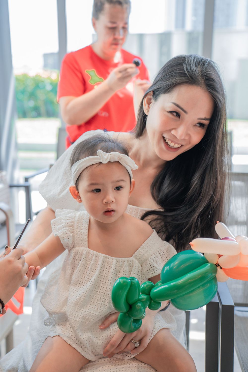 A party scene with balloon decorations and festive atmosphere.