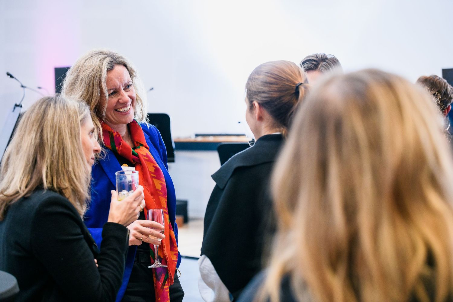 Business networking event with attendees engaged in animated conversation.