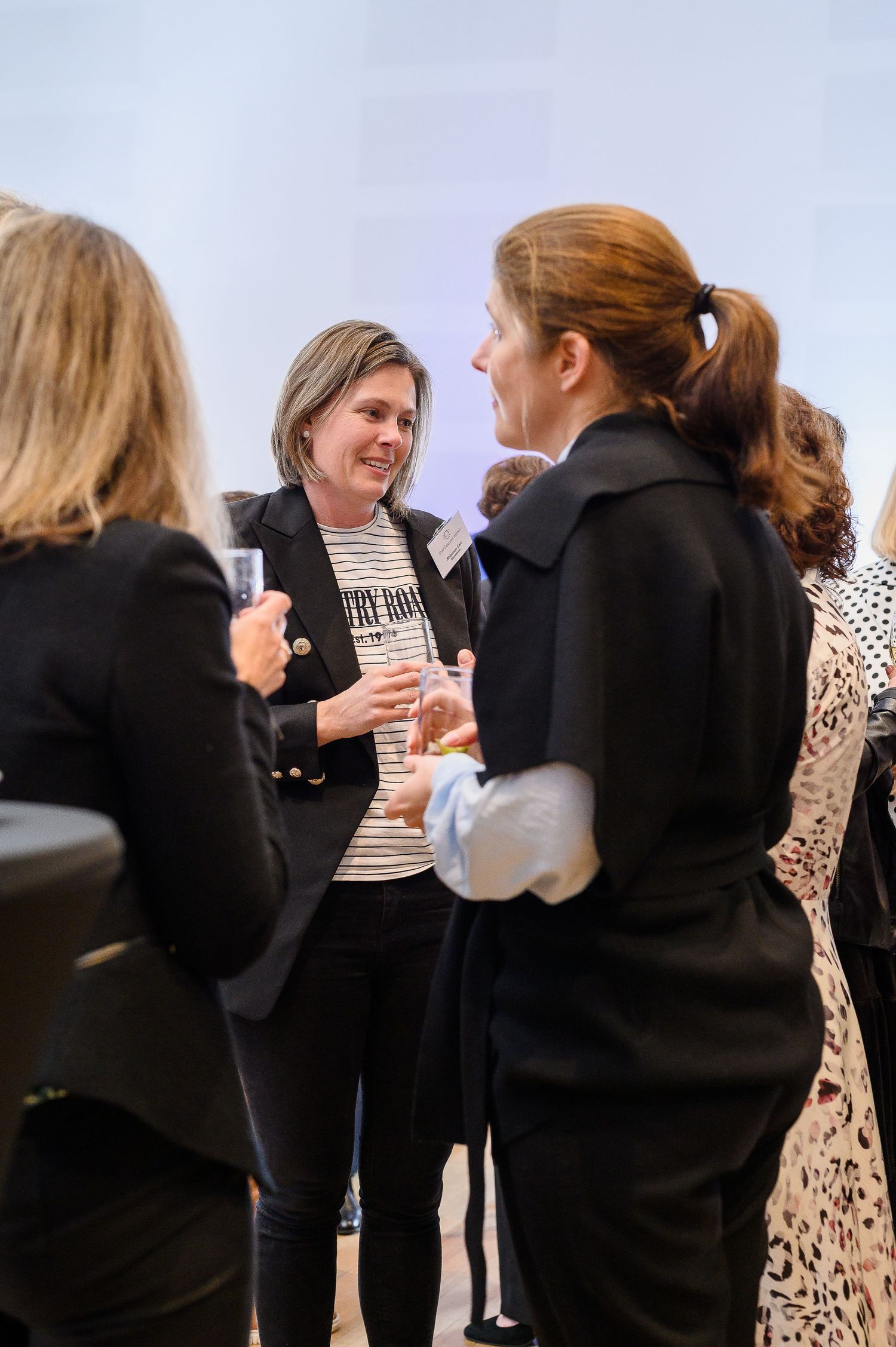 Small group engaged in lively conversation at a professional networking event.