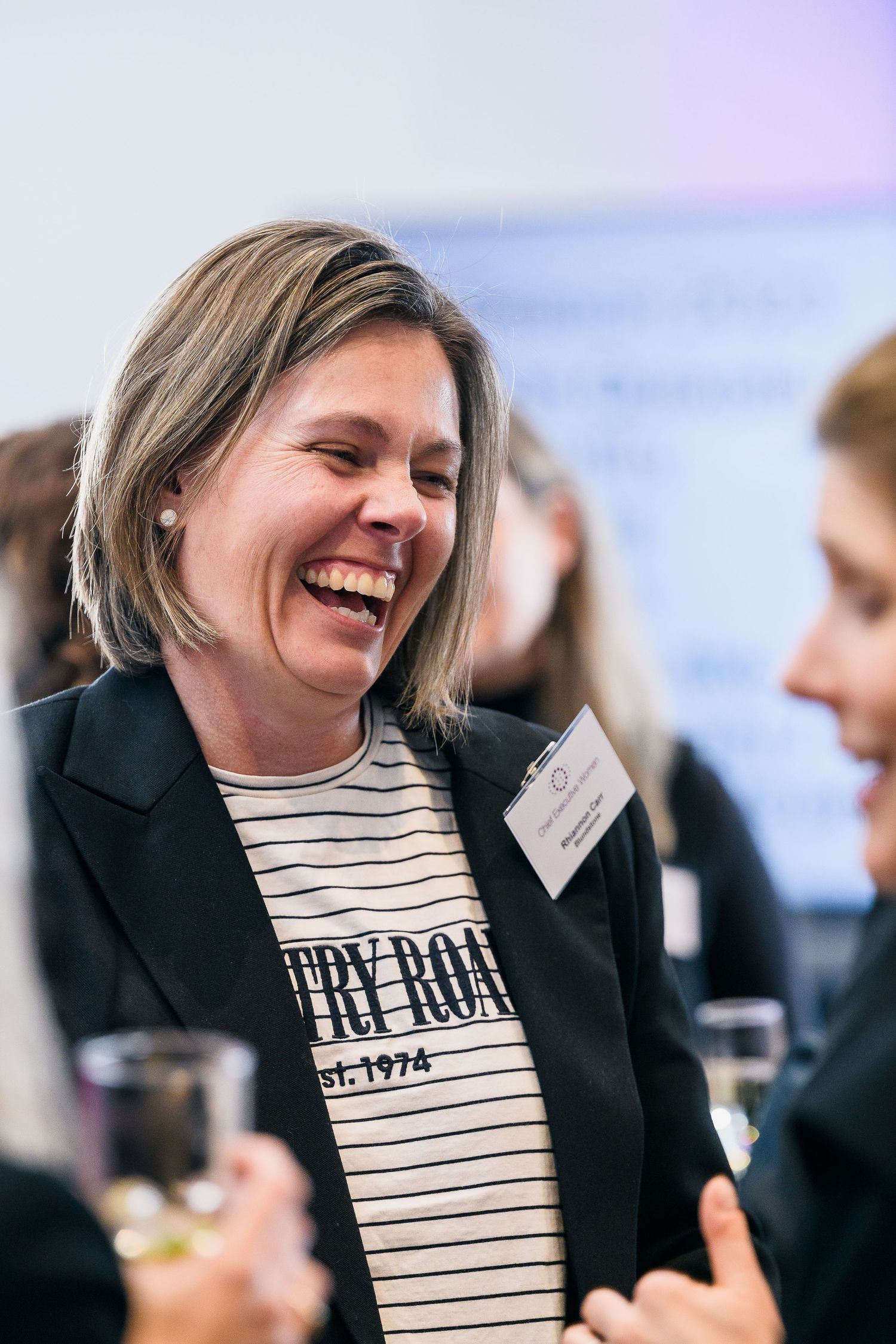 Candid moment captured at a business networking event showing warm engagement between attendees.