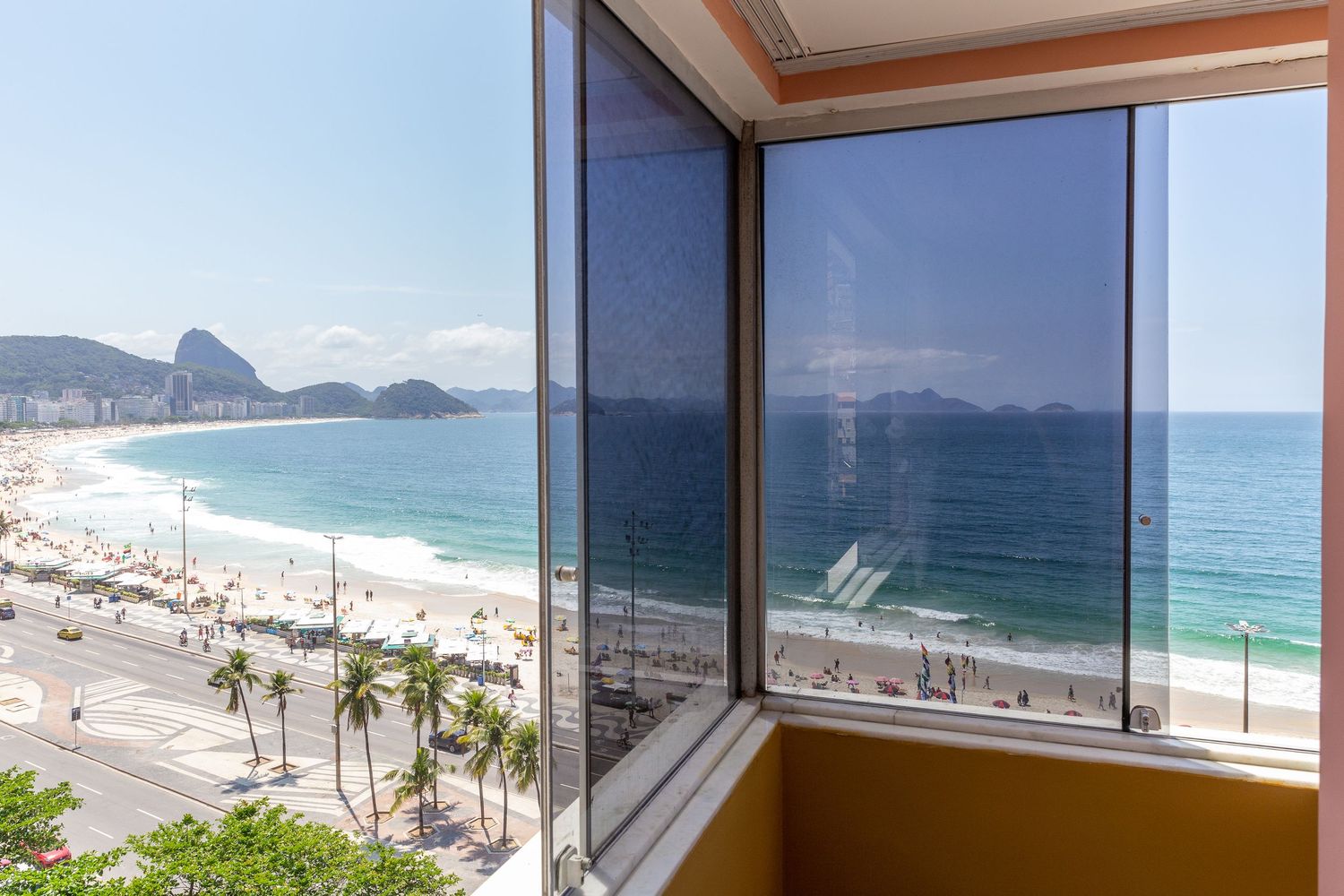 Stunning oceanfront view of Copacabana Beach in Rio de Janeiro from high-rise balcony.
