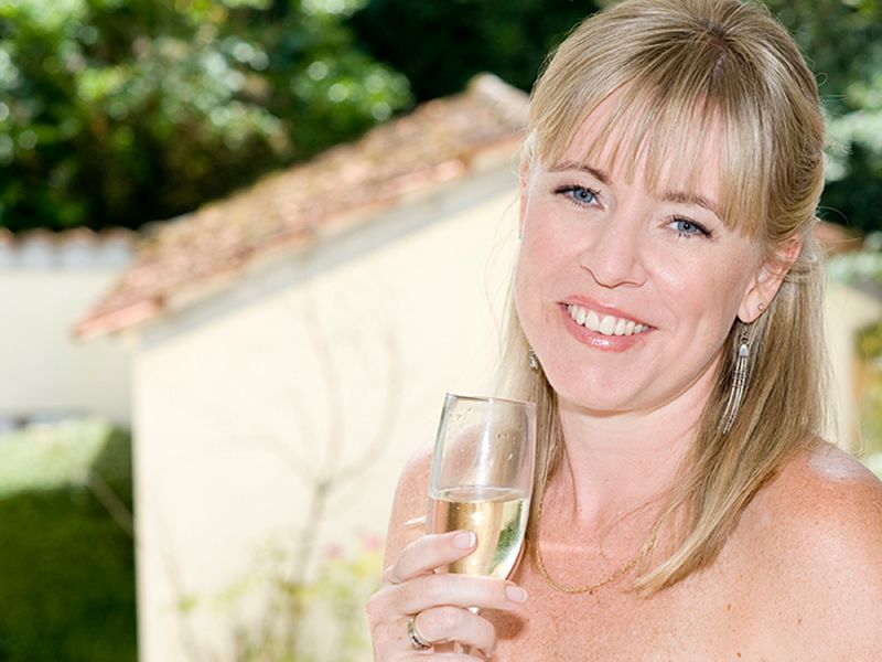 A bride in High Wycombe holds a glass of Champagne, preparing for her wedding day. Photography by Abigail's Studio.