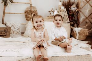 Series of milestone photos showing baby's growth progression on white blanket.