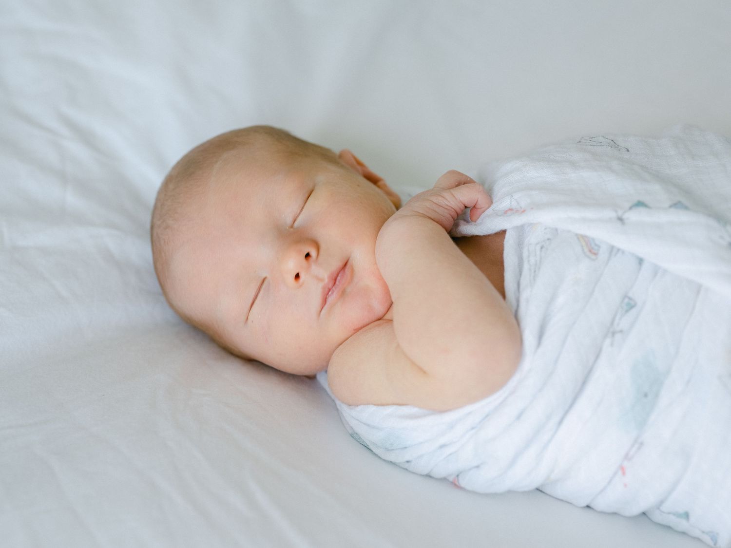 sleepy boy wrapped up on the bed in Davis County, Layton, Utah.