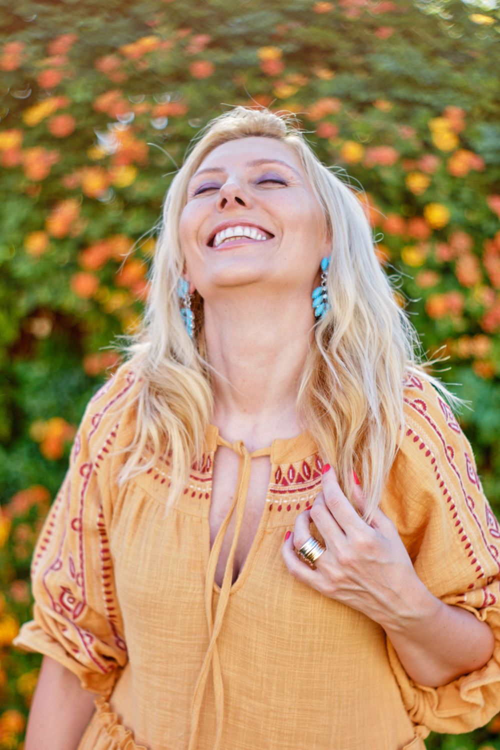 Joyful moment captured outdoors with orange flowers in background.