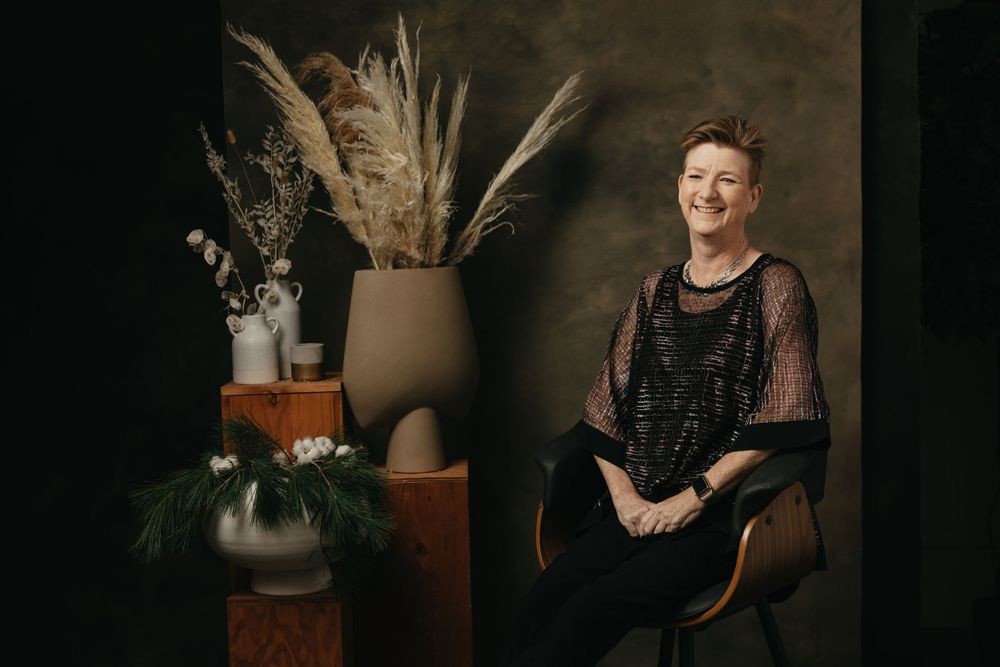 Artistic studio photography with vintage furniture and natural elements.