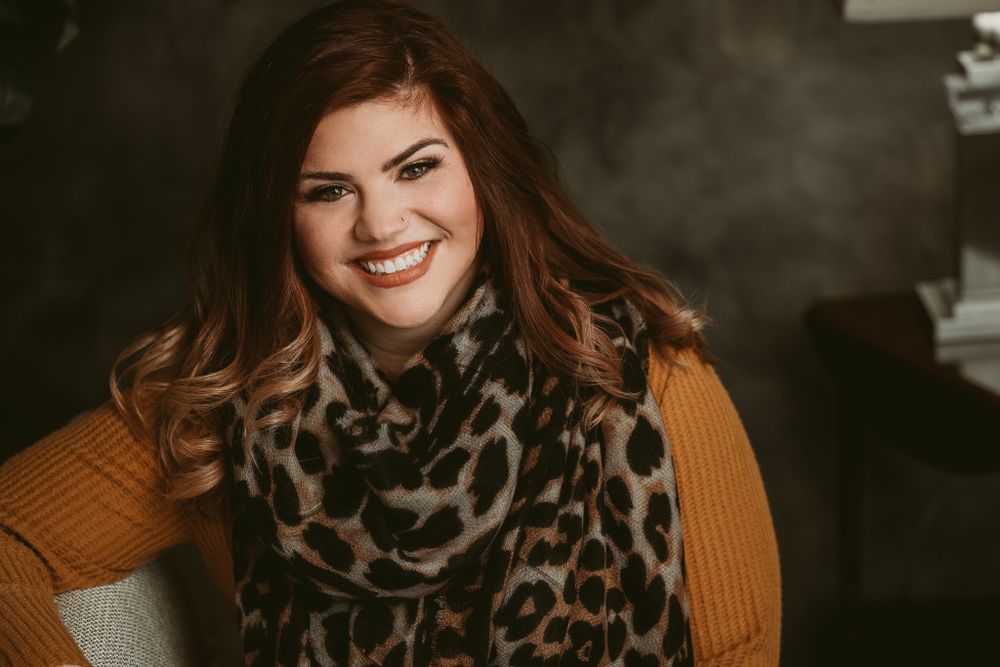 Cozy autumn portrait featuring leopard print scarf and orange sweater.