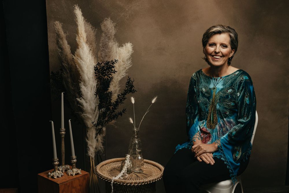 Elegant portrait featuring teal dress and dried pampas grass decorations.