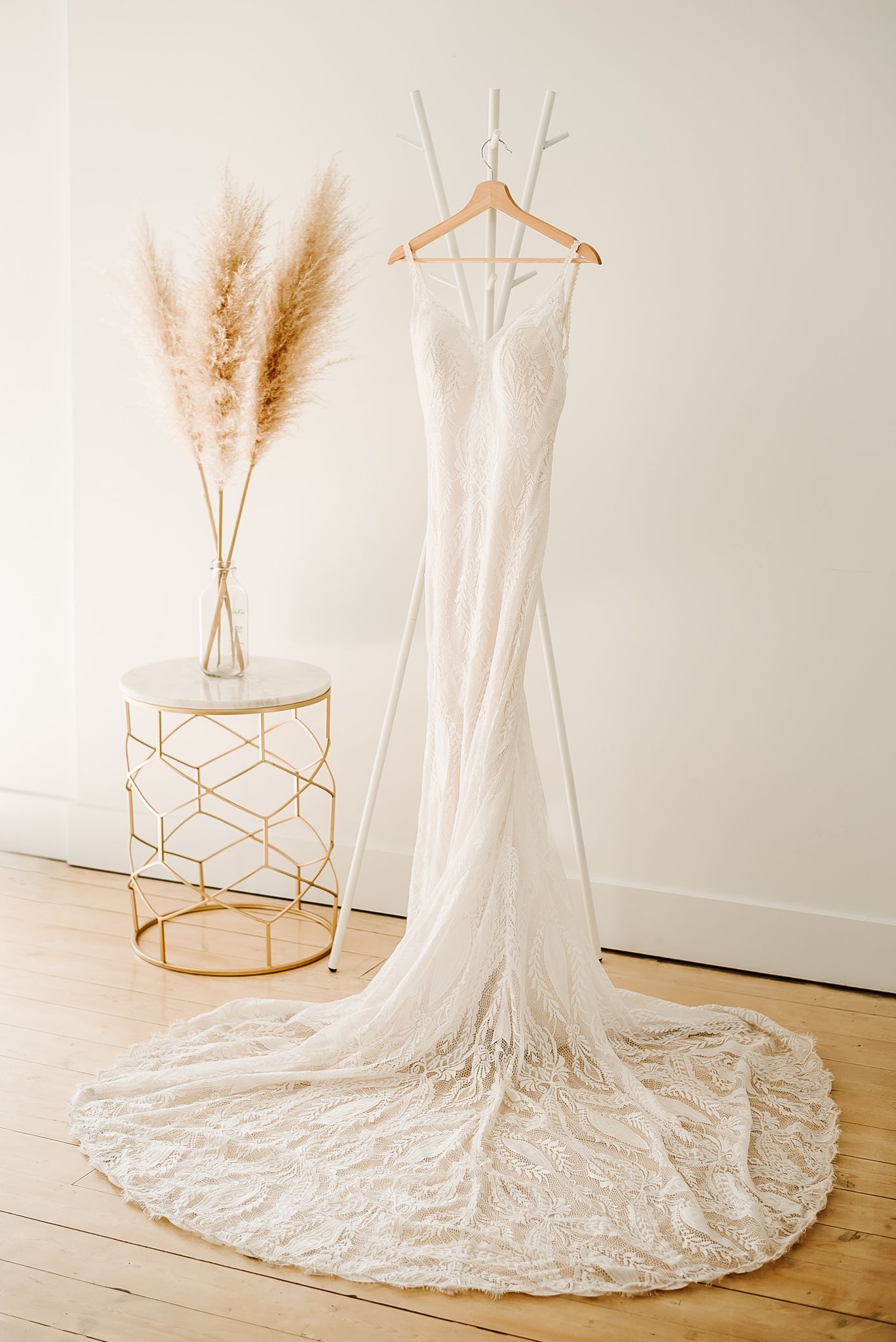 lace wedding dress displayed for wedding day. Photo by Vancouver wedding photographer, Kari Mills Photography.