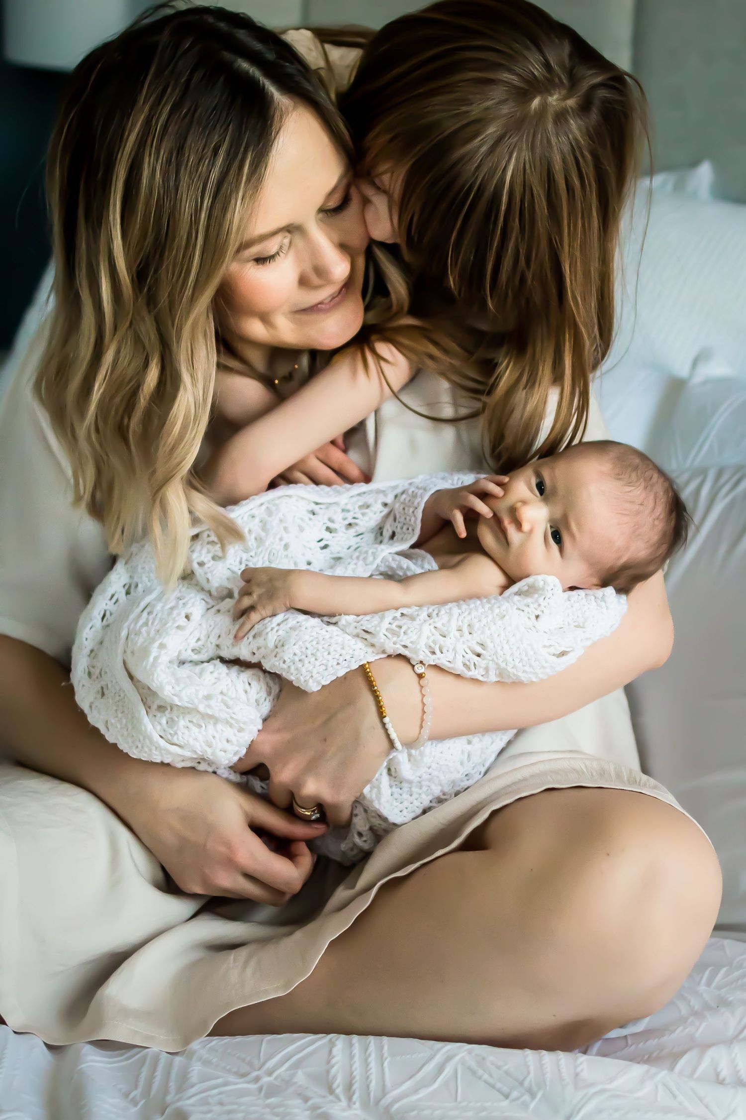 Beautiful, authentic motherhood moment during lifestyle newborn photos at home by Calgary photographer.