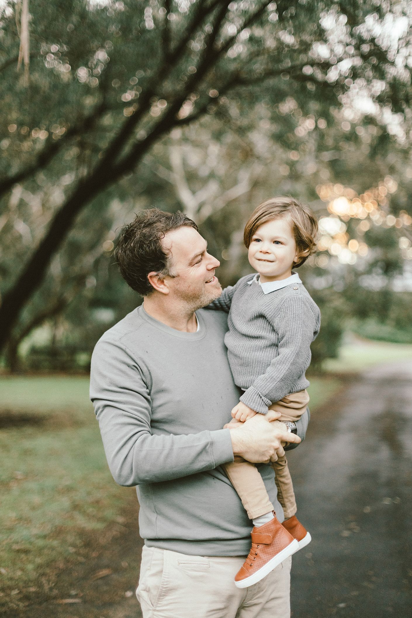 A sweet bonding moment between parent and child on a park pathway.