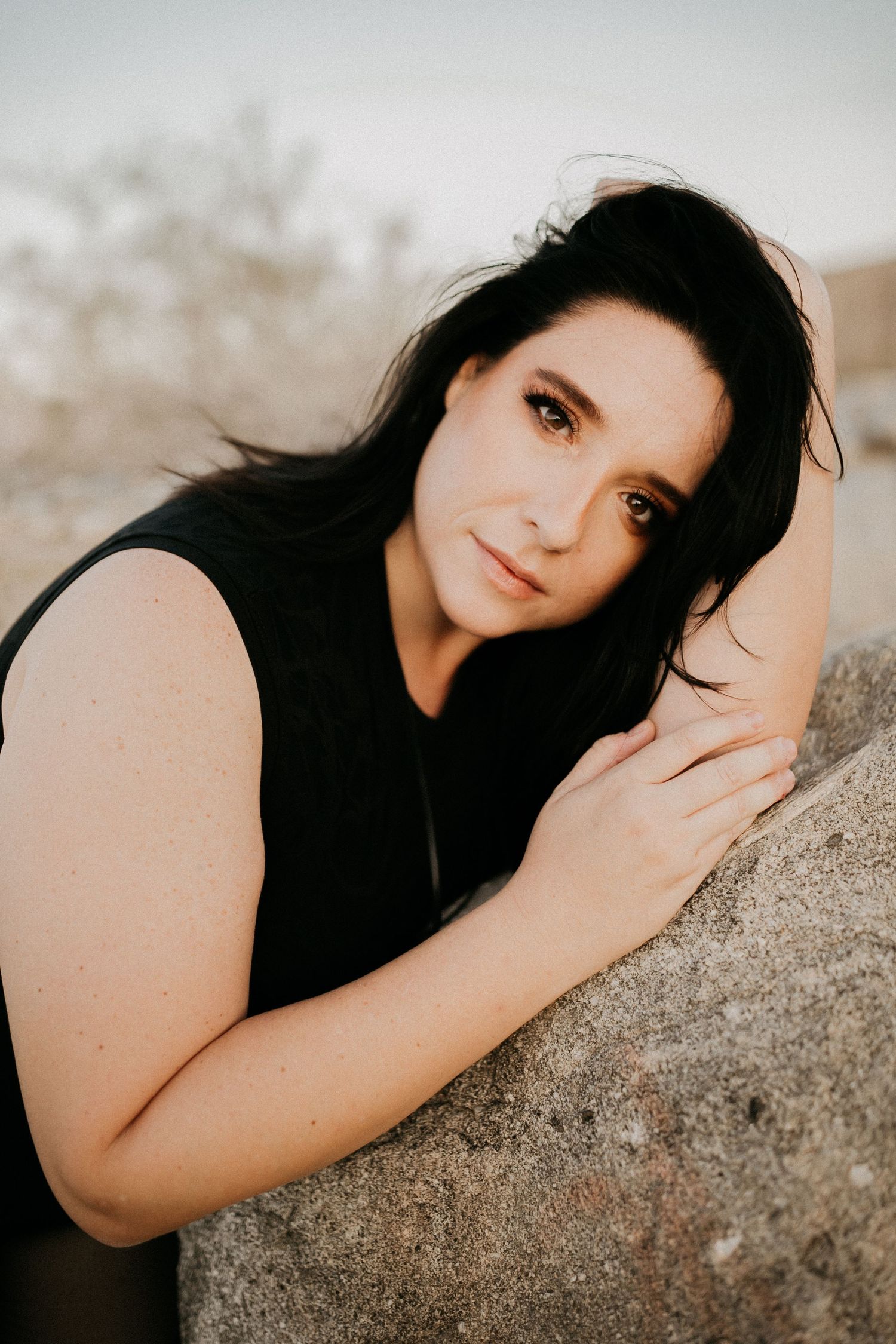 Portrait against rocky background in warm sunset lighting.