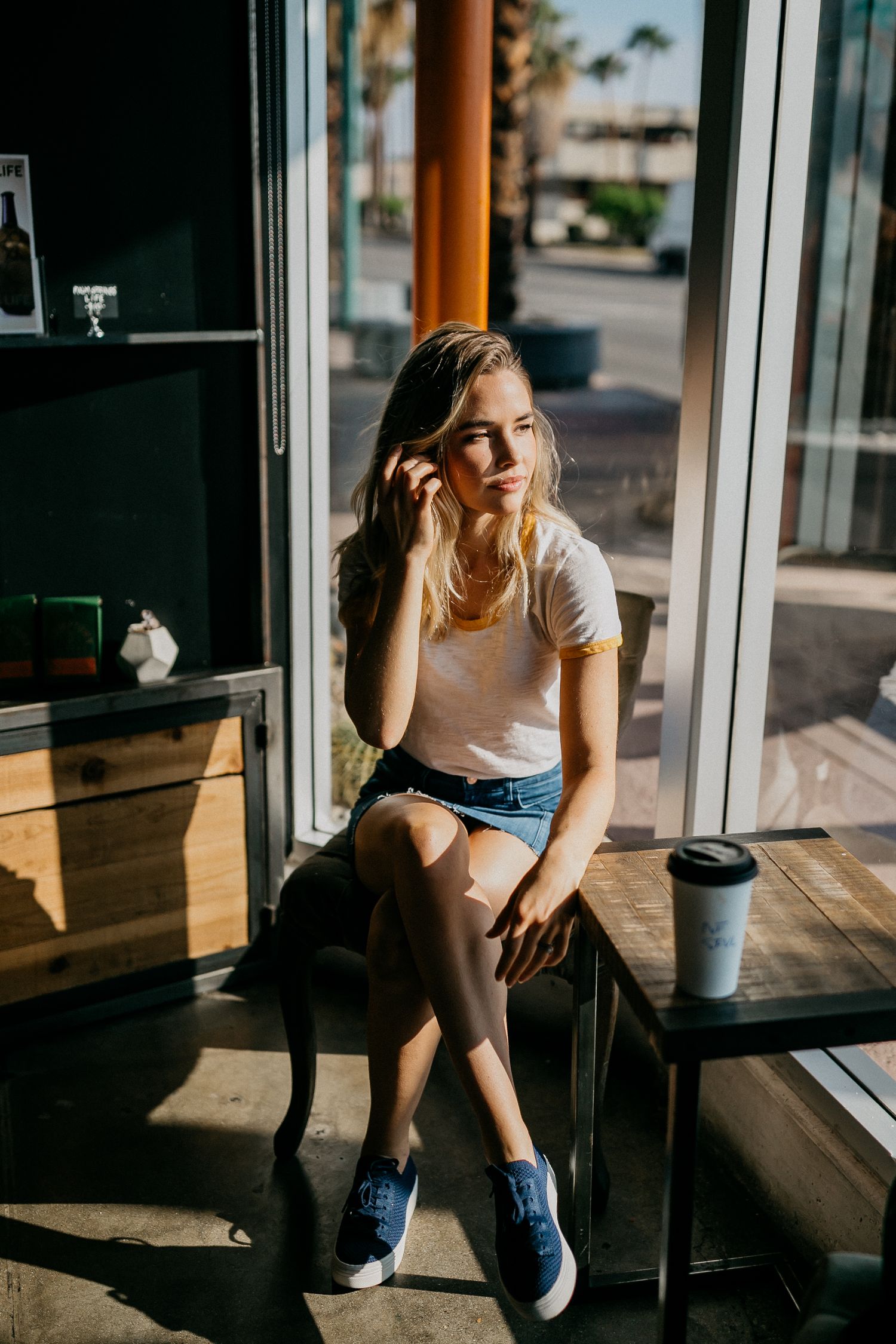 Coffee shop window seat with natural lighting and casual modern vibe.