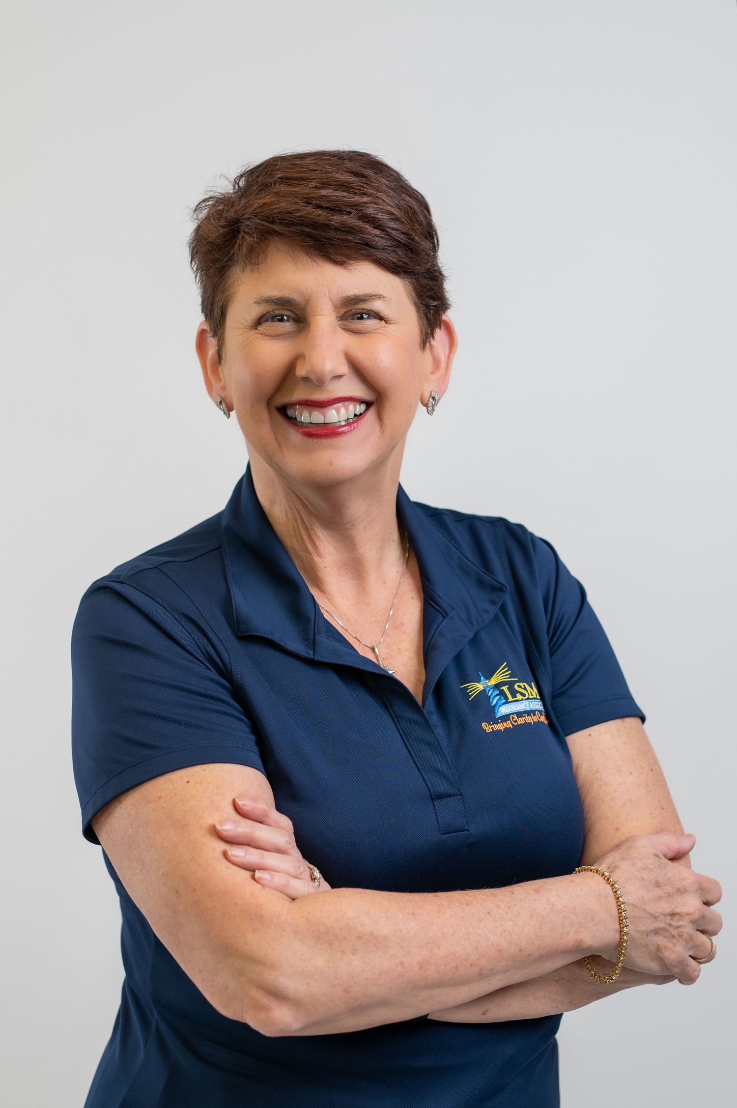 Professional woman in navy blue polo shirt showing confident poses against white background.
