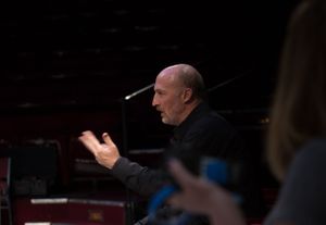 People in a dimly lit theater space during what appears to be a performance or rehearsal.