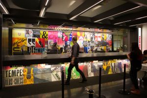 A panoramic view of a colorful mural-covered corridor or underground passageway.