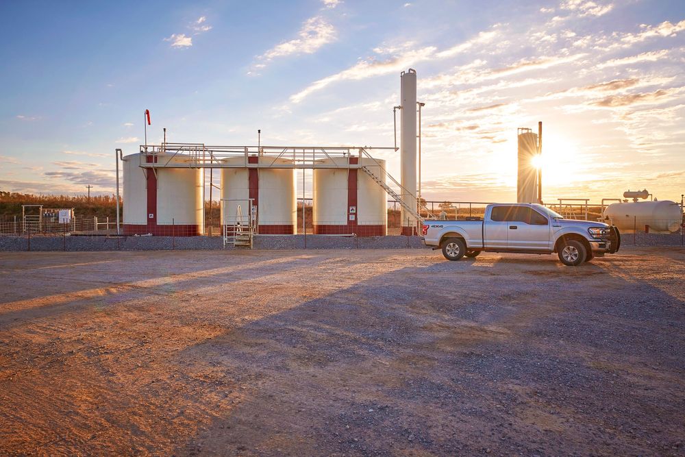 Oil and gas well site with truck