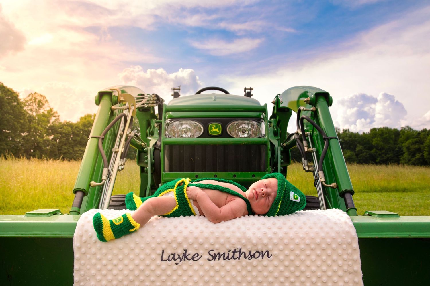 Vintage green tractor displayed in a sunny field during golden hour.
