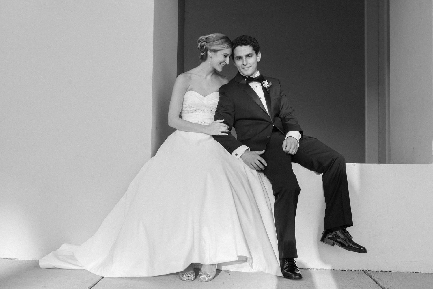 A black and white wedding photograph collage shows romantic poses of a couple on their special day.