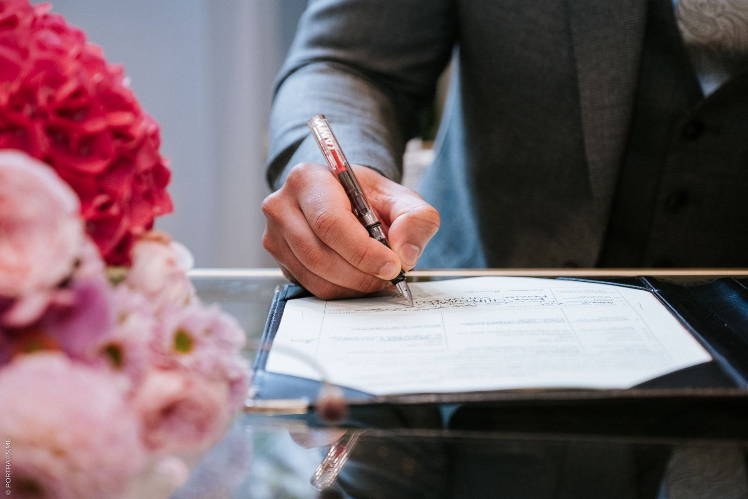 Husband signs the register