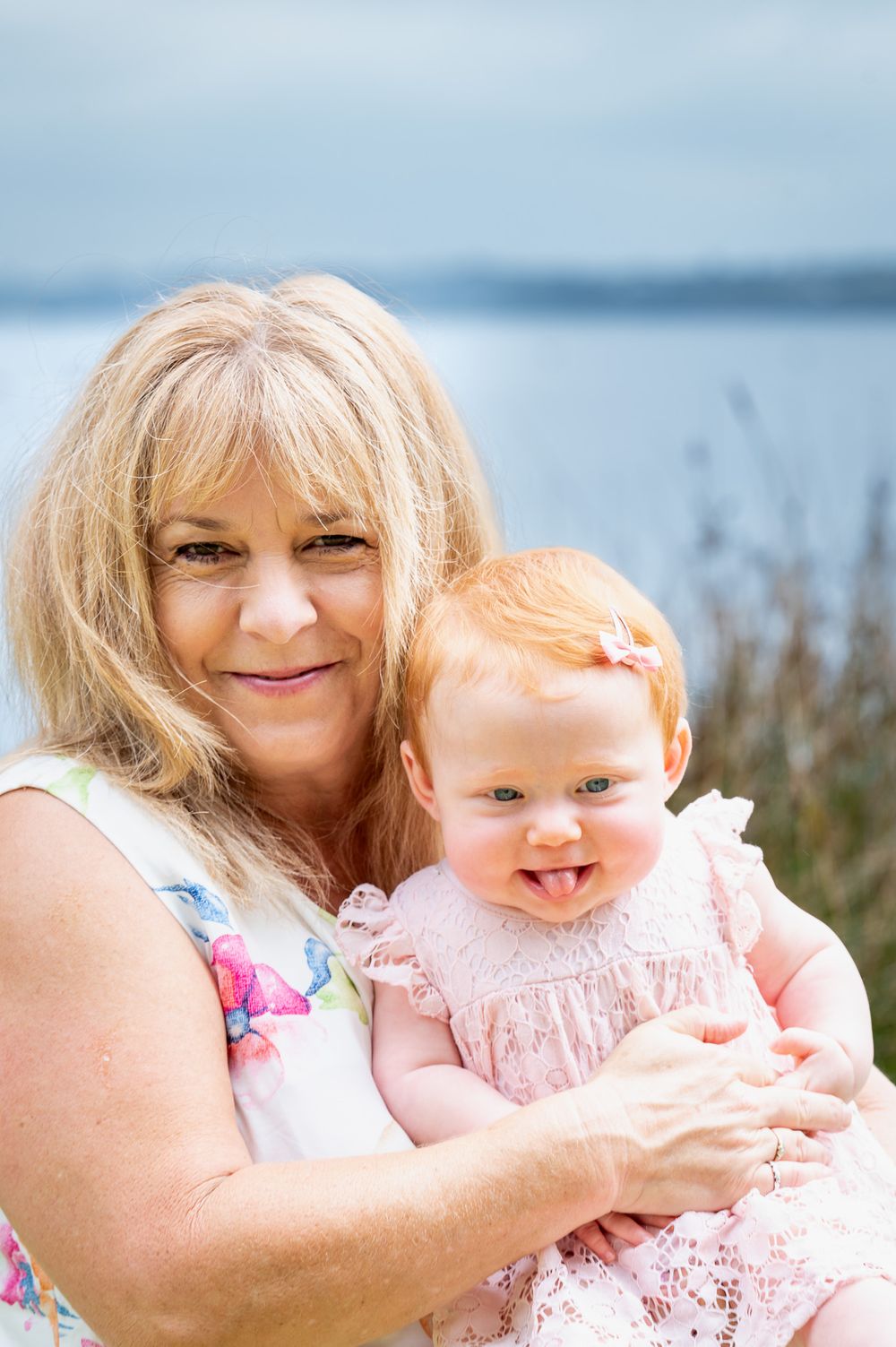Nan and granddaughter hugging by the lake