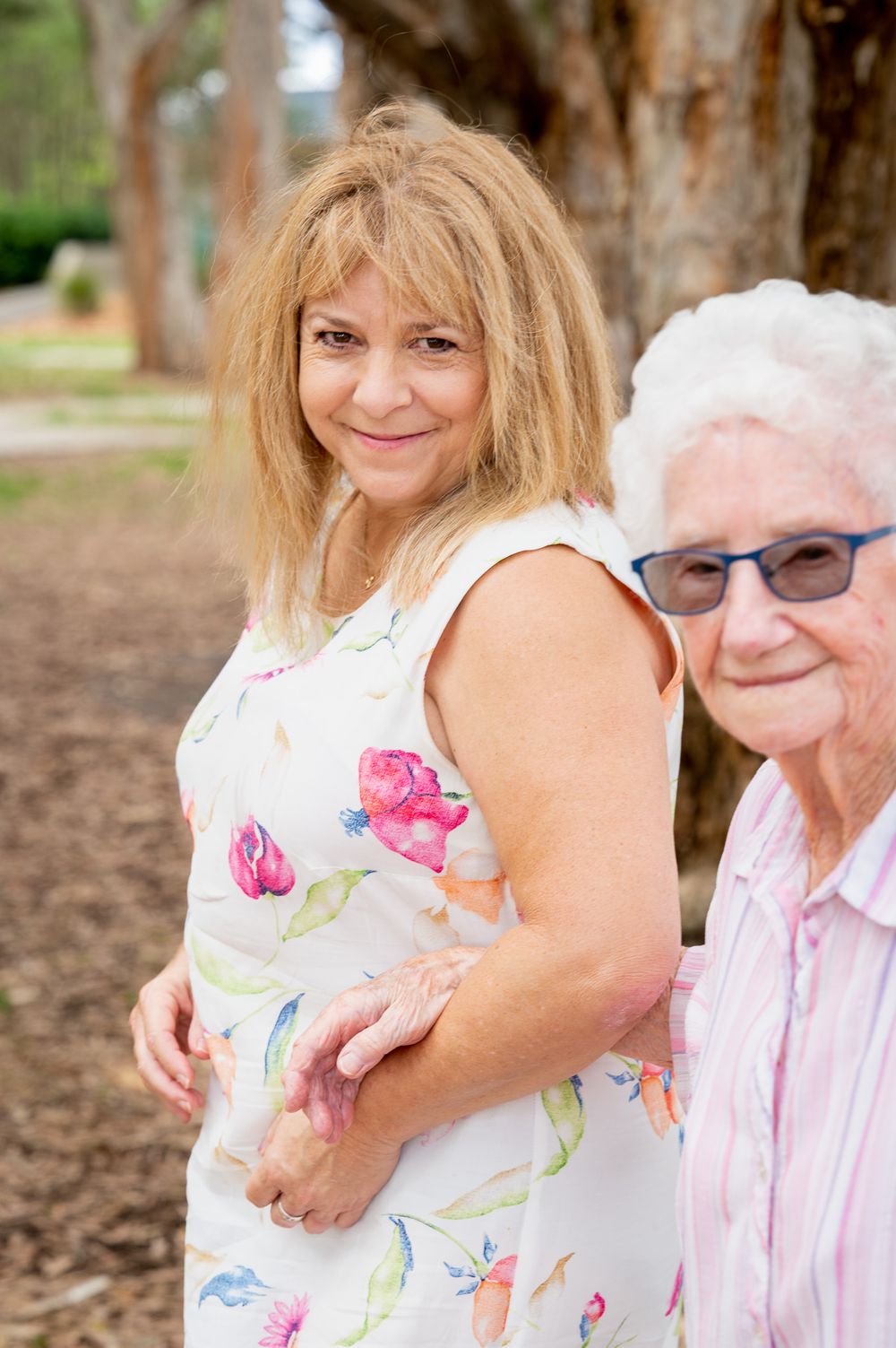Mum & Daughter walking by the bush