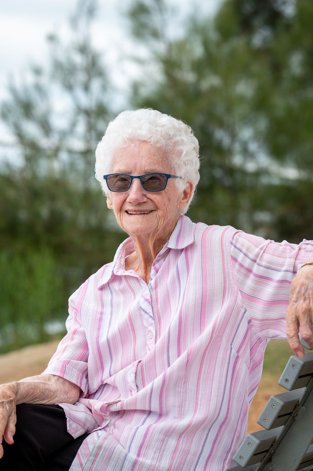 A composed portrait photo of a great grandmother resting casually