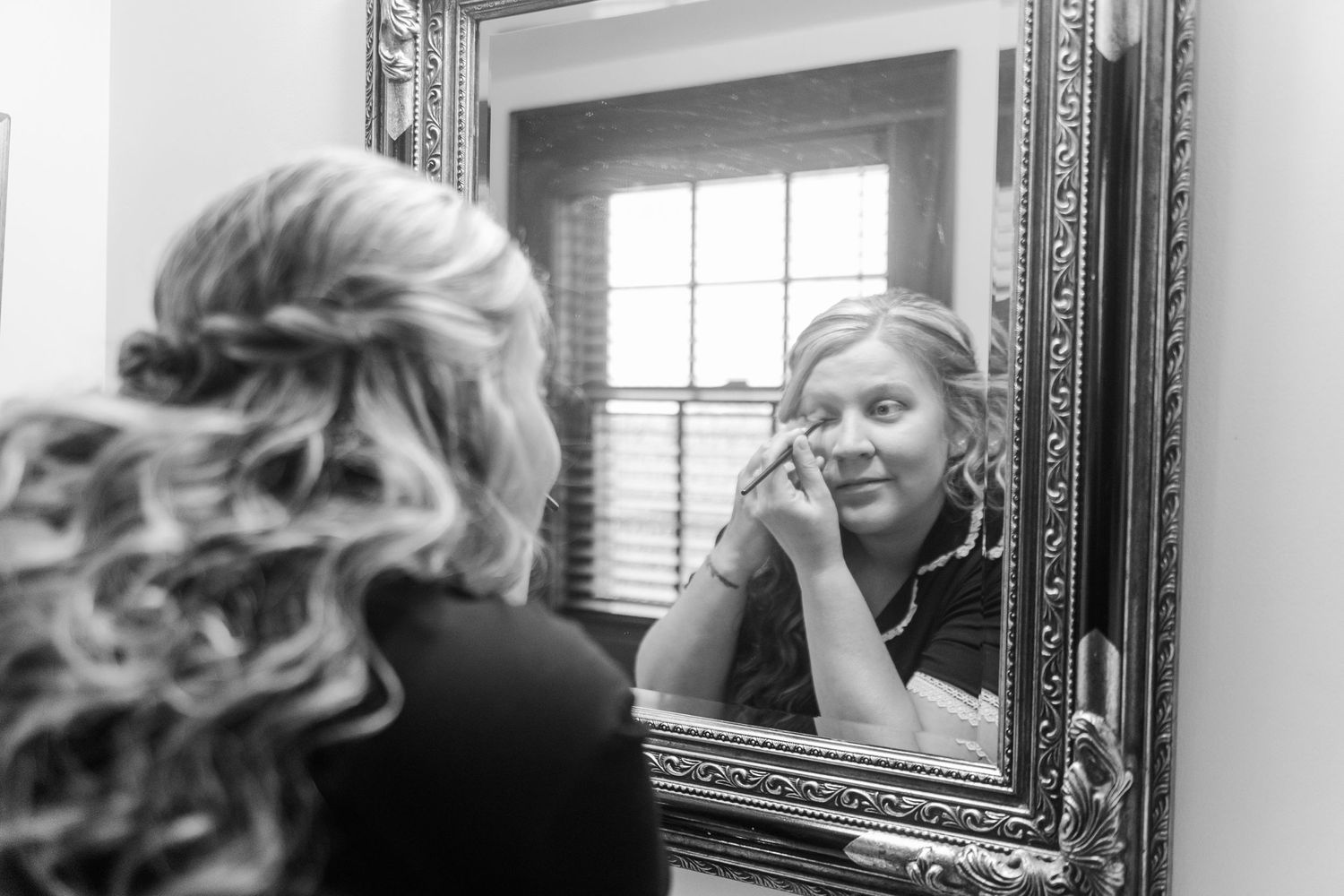 Reflection in an ornate framed mirror in an indoor setting.