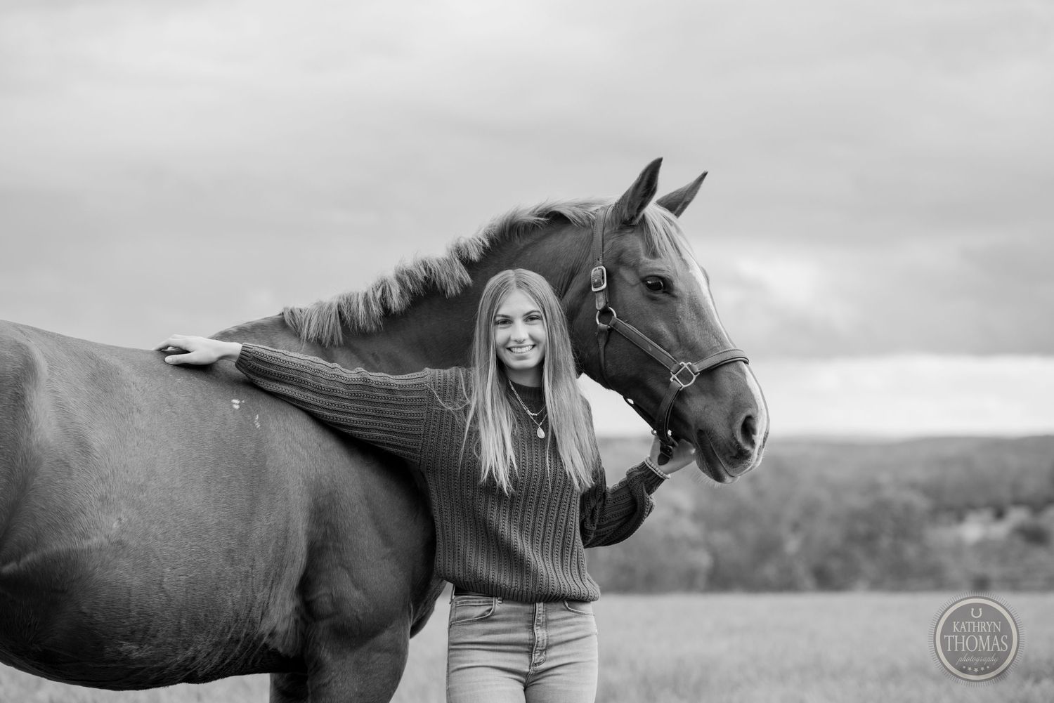 A monochrome portrait showcasing a close connection between a horse and its companion in a field.