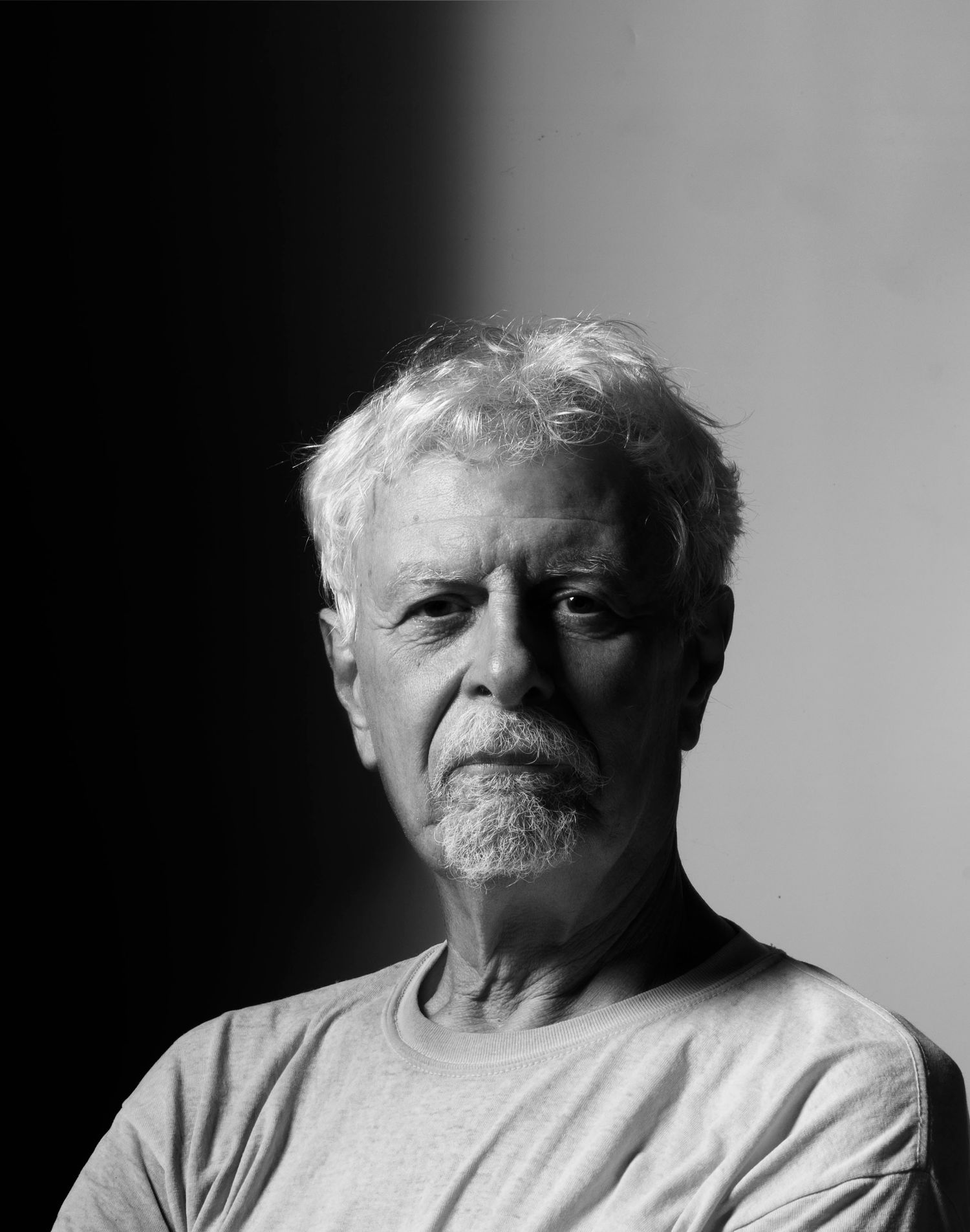 Black and white portrait with dramatic side lighting.