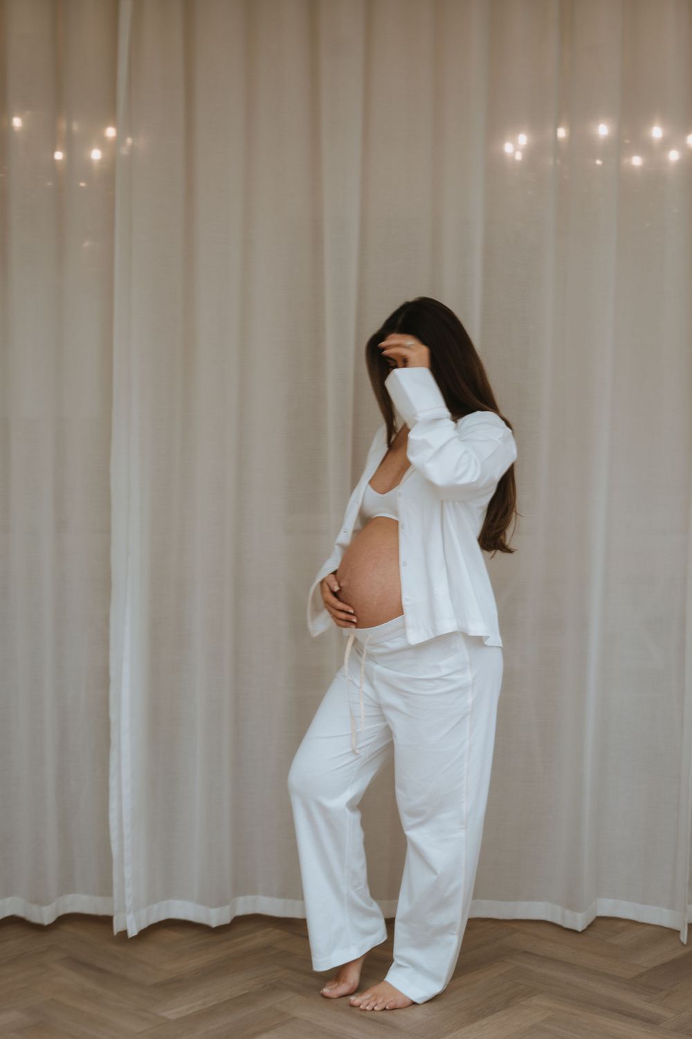 minimalist aesthetic photograph of mother holding bump