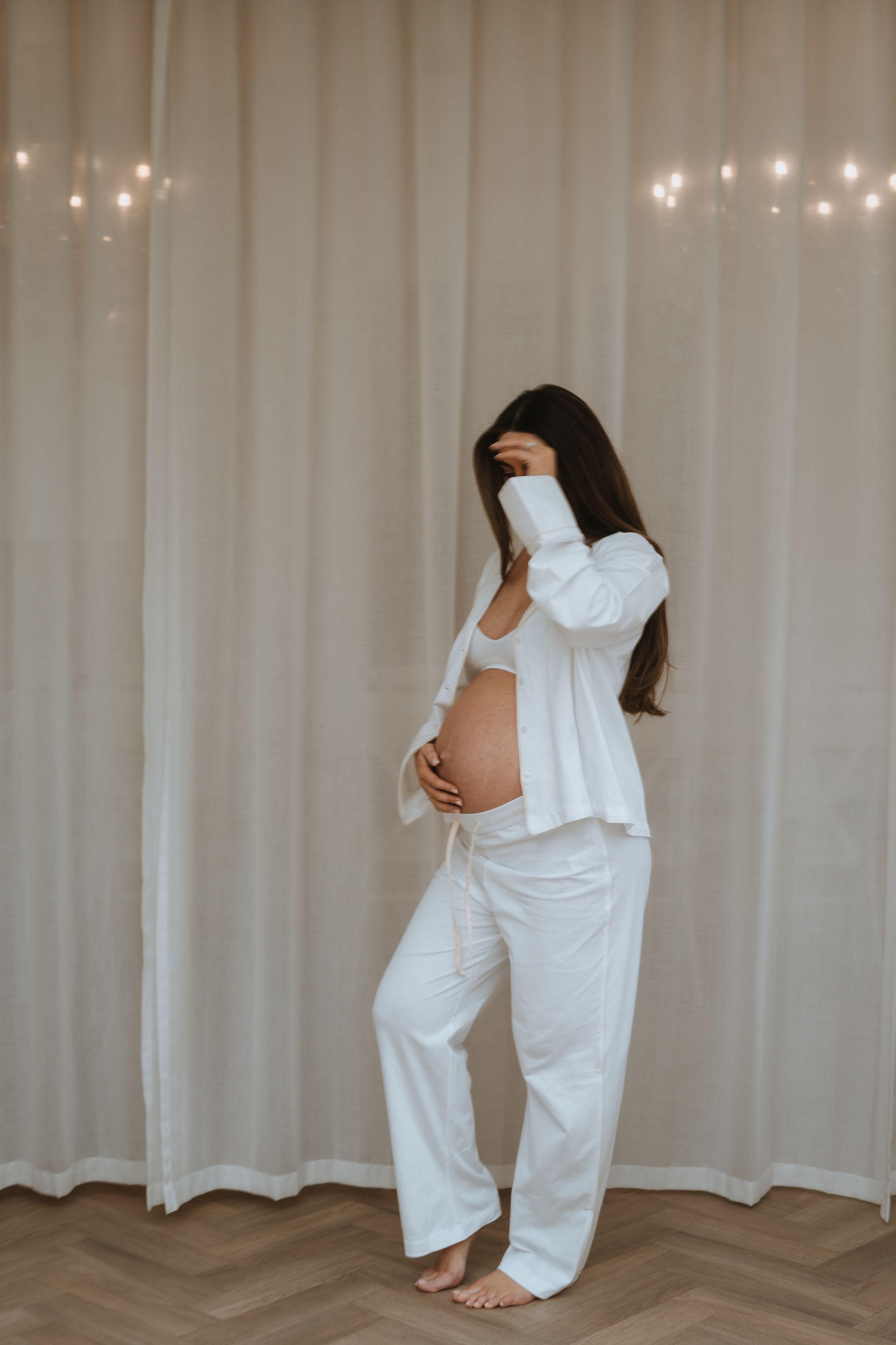minimalist aesthetic photograph of mother holding bump