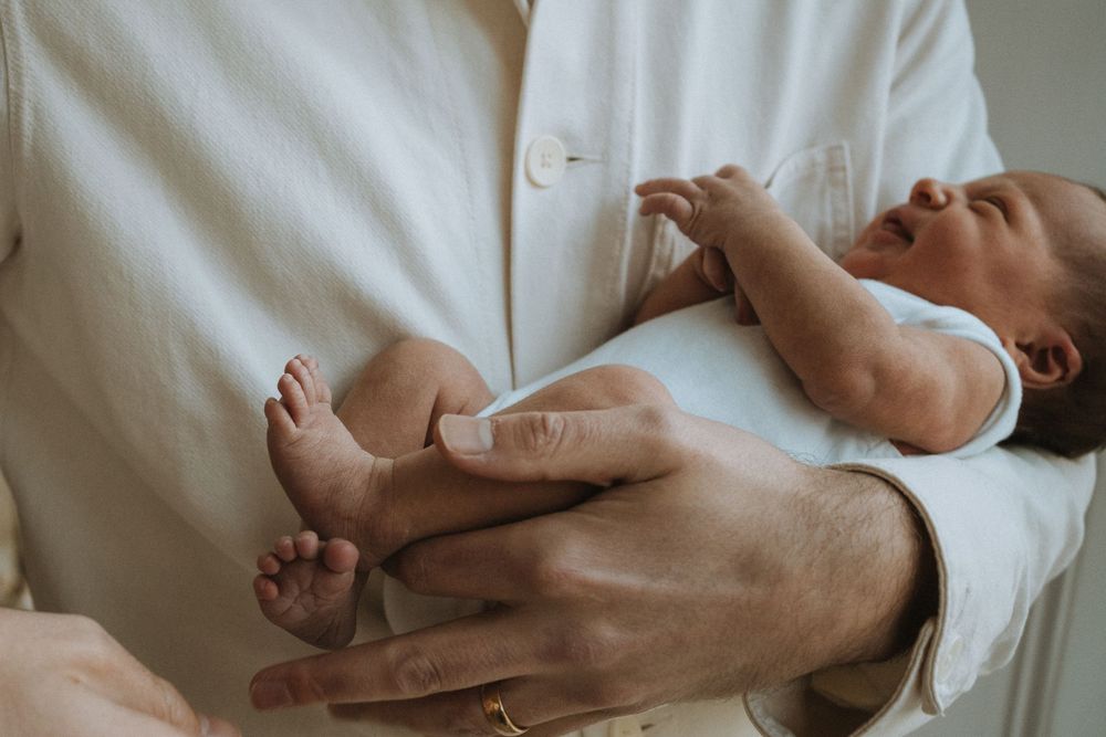 dad holding his newborn daughter