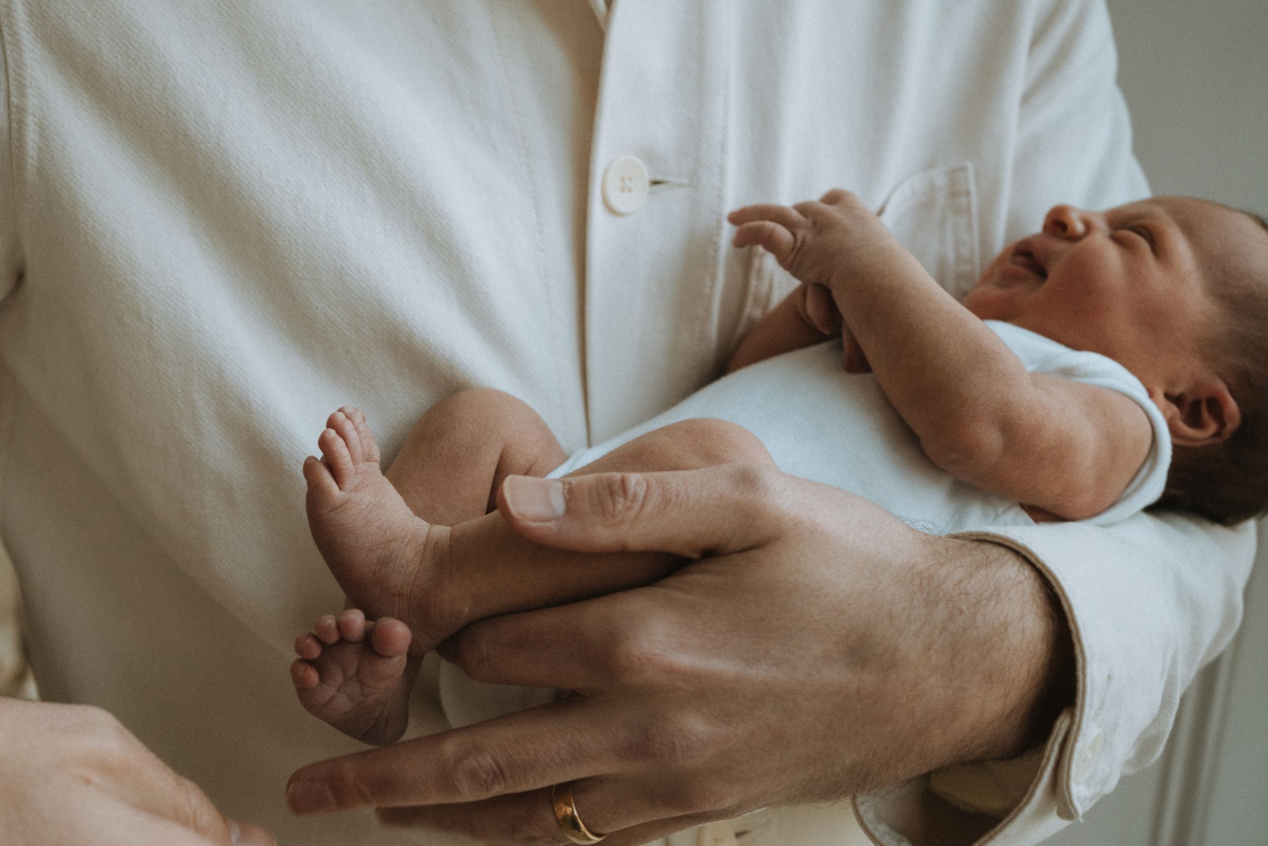dad holding his newborn daughter