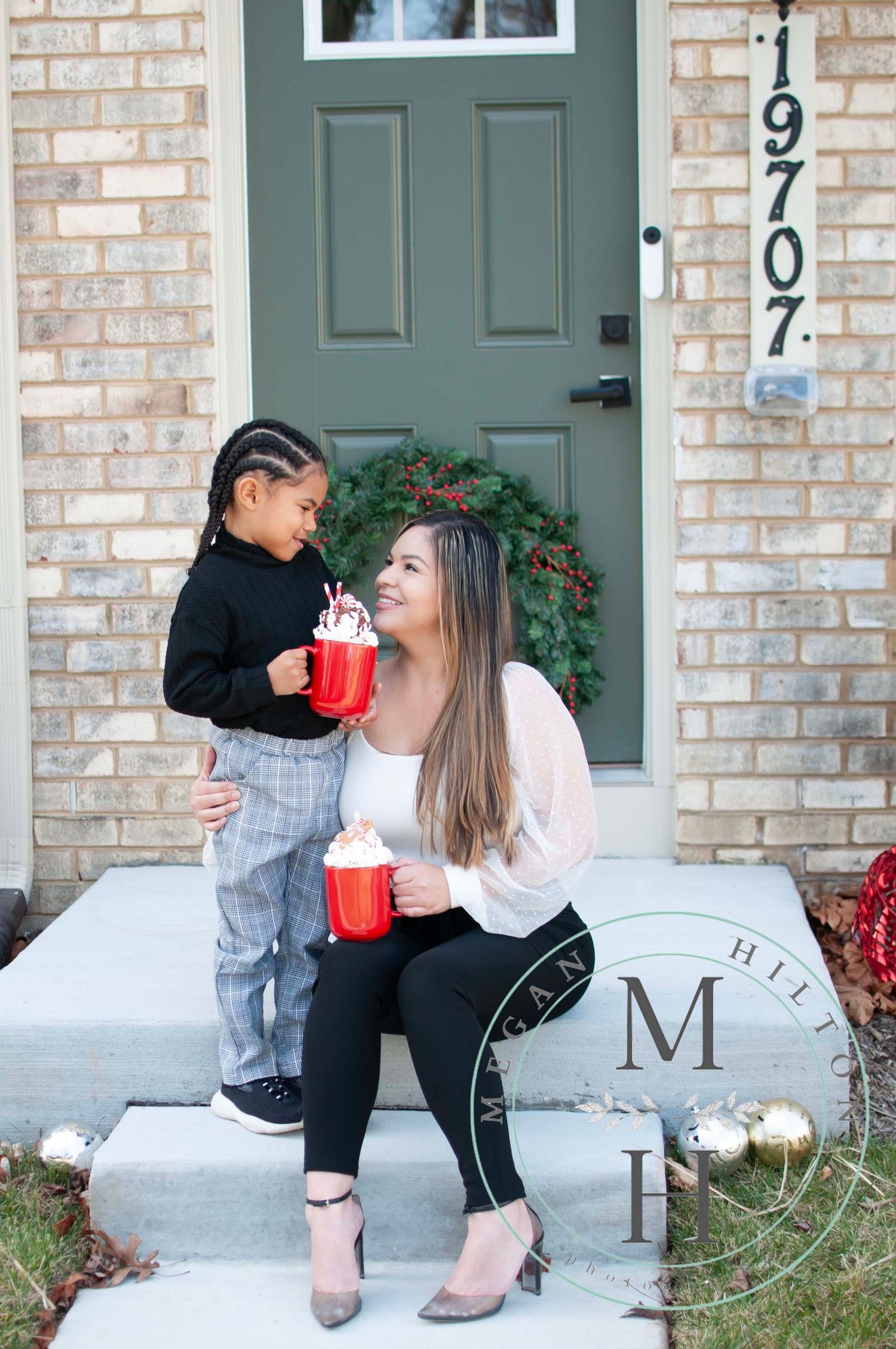Mom and son drinking hot chocolate on front step