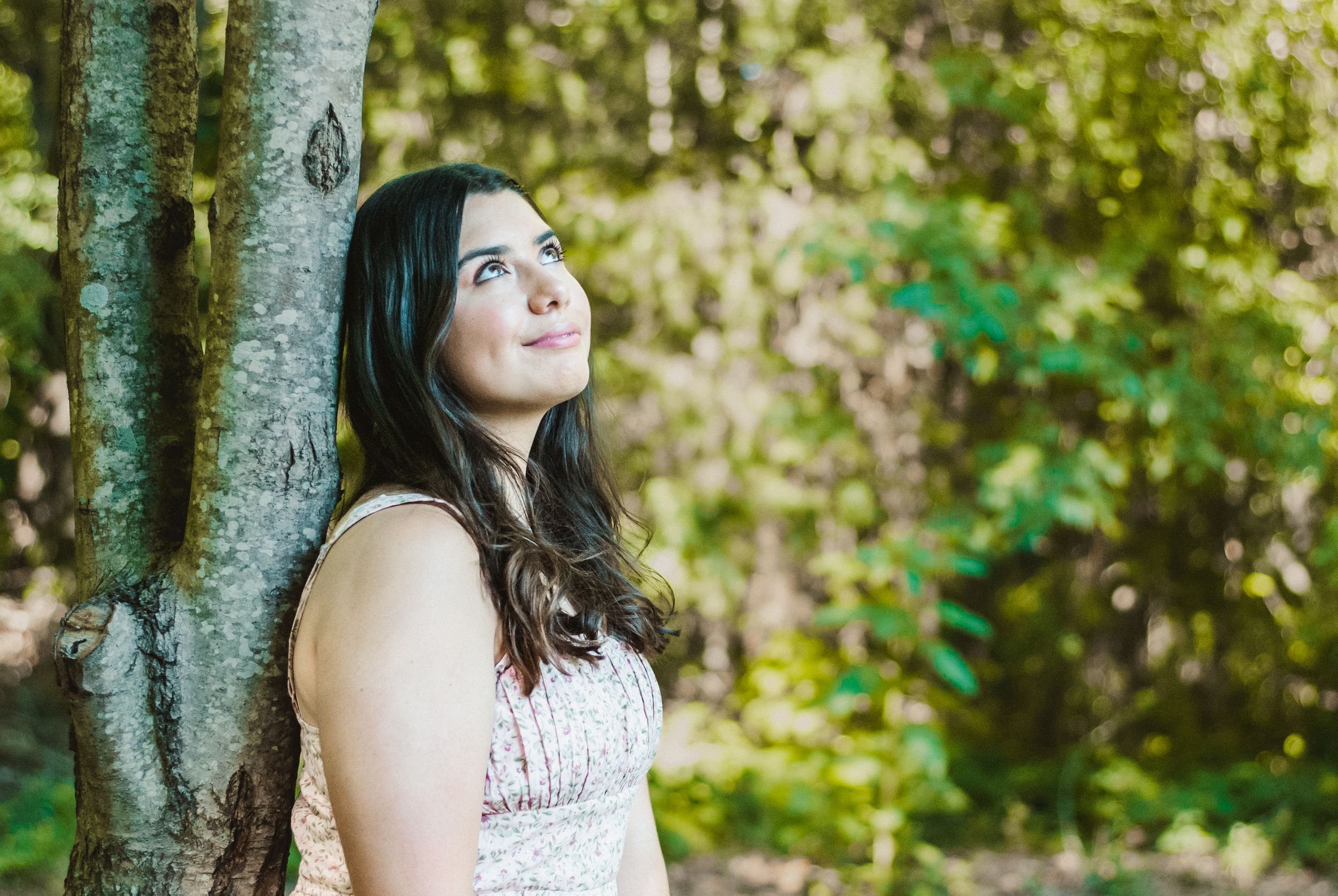 Travel storytelling photo of a woman daydreaming by a tree in Charlotte, North Carolina
