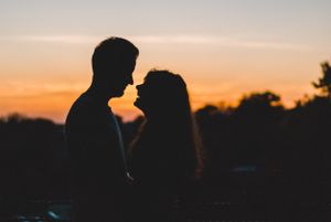 Candid travel storytelling photo of a couple laughing at sunset in downtown Greenville, South Carolina