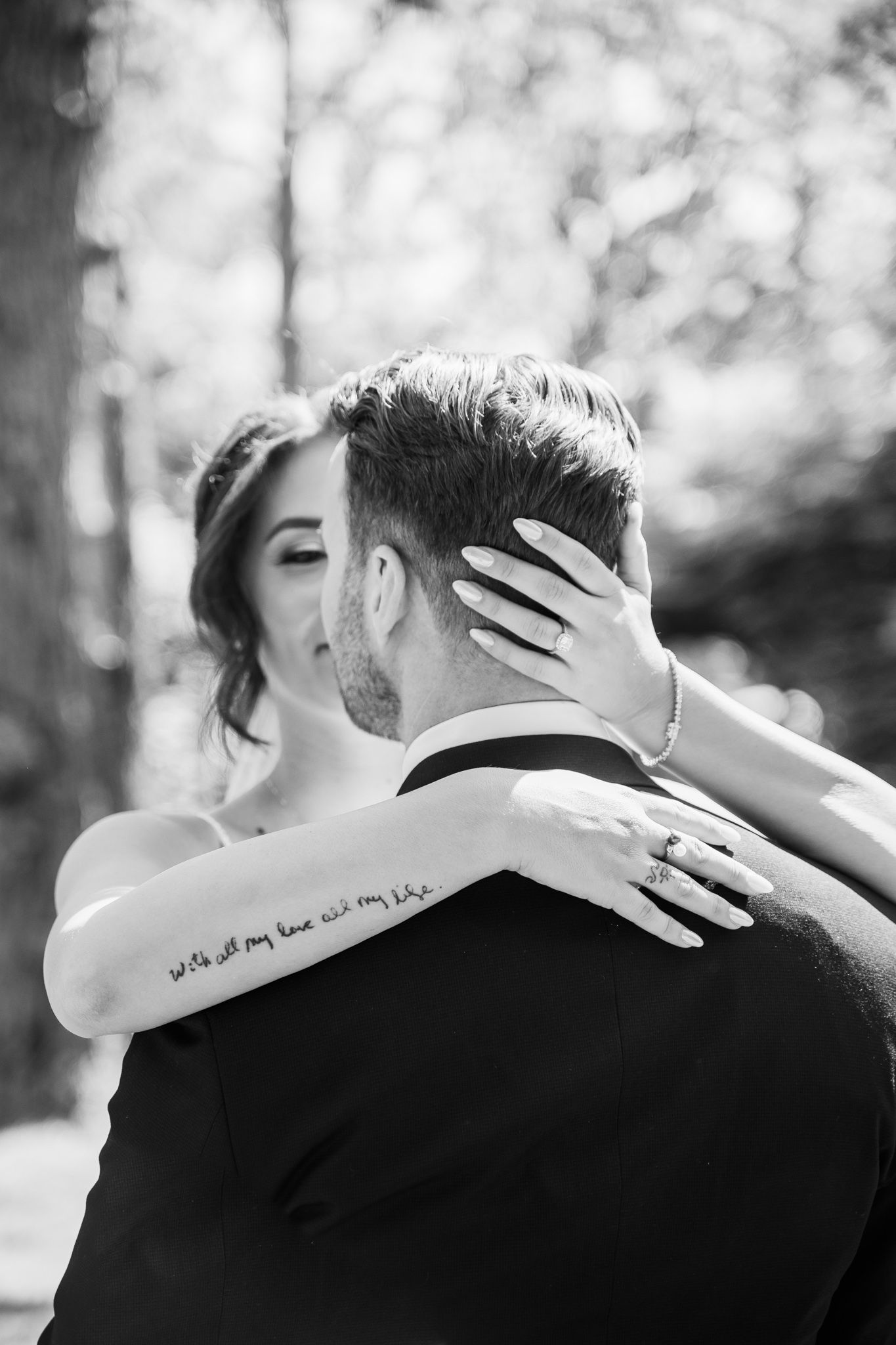Bride embracing groom in a tender moment of intimacy before their ceremony.