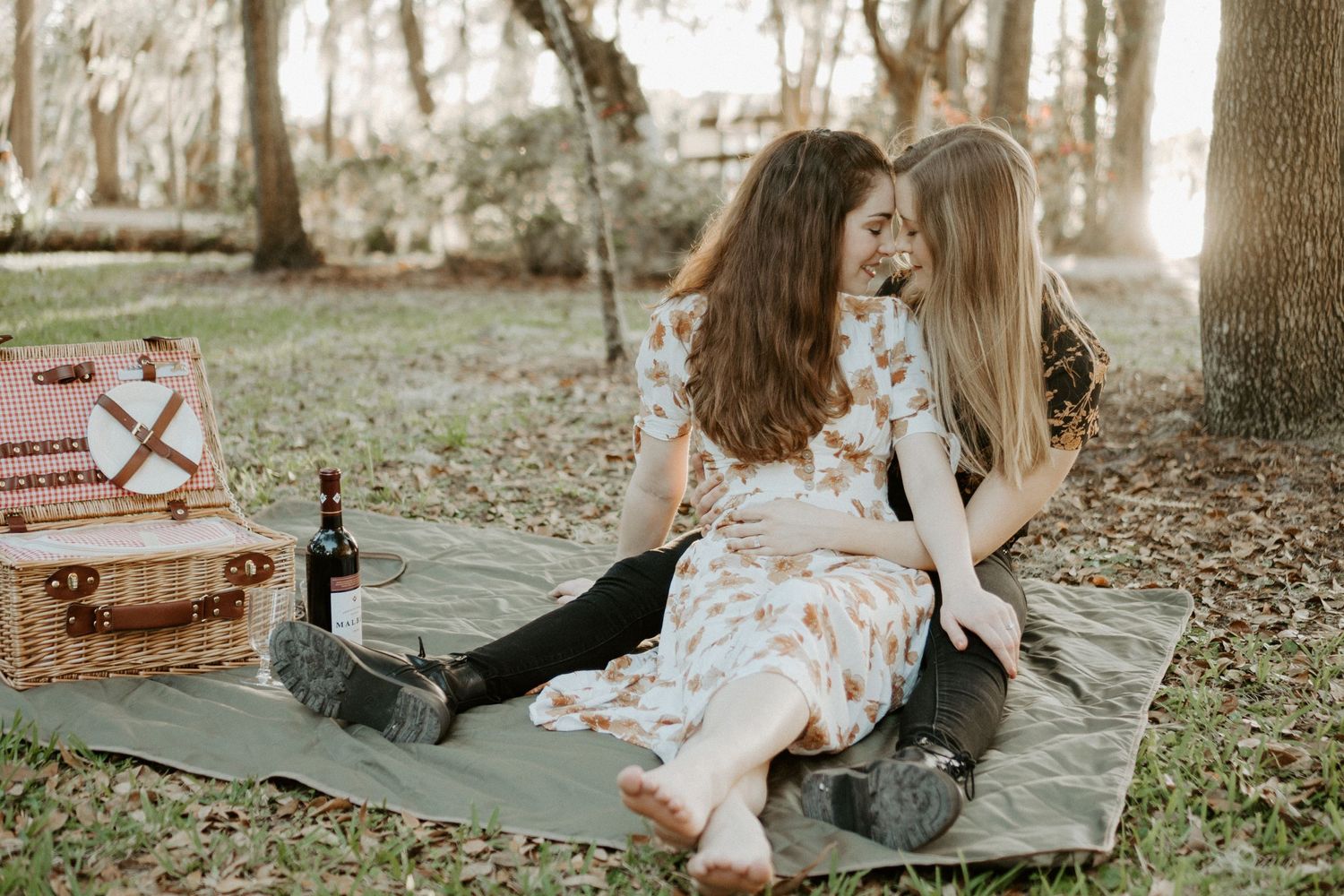 LGBTQ Couple having a picnic and embracing each other at sunset in Winter Park Florida