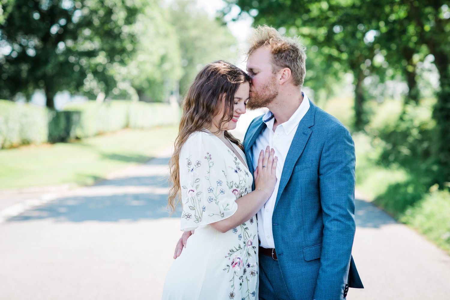 Couple in a relaxed embrace in the sunshine after their elopement