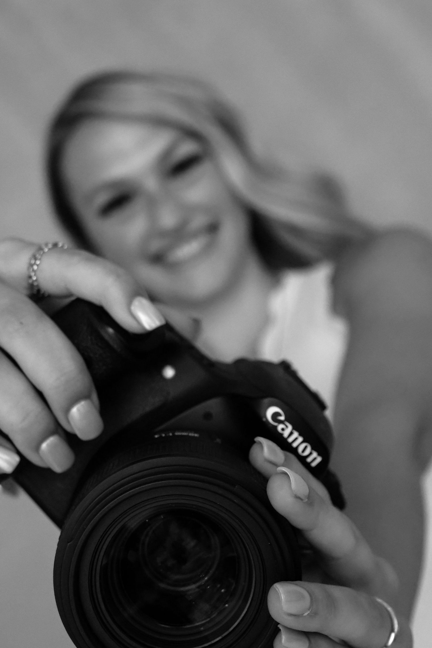 Close-up shots of Canon camera lenses in black and white photography style.