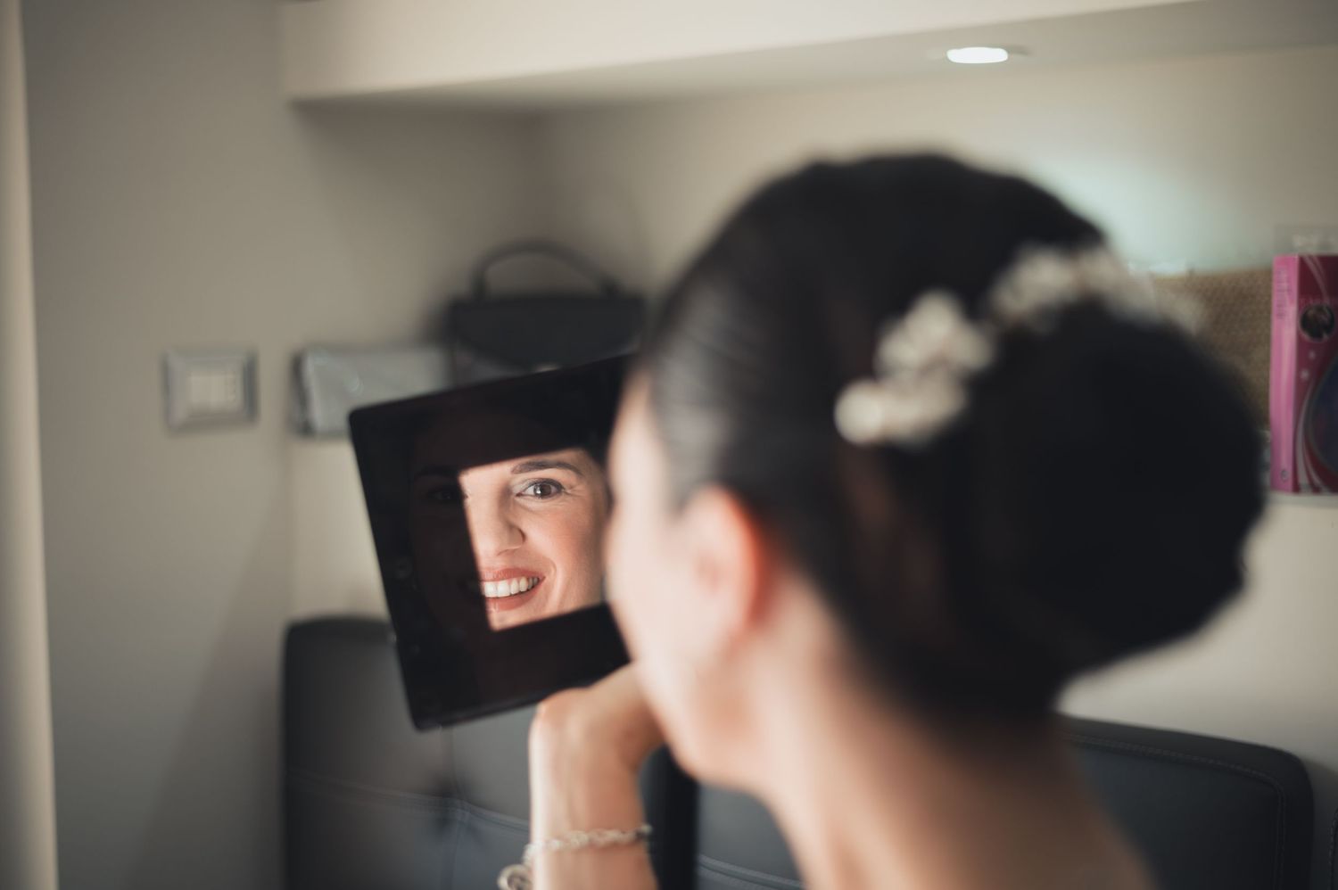 Mirror reflection shows preparation for special event in makeup studio.