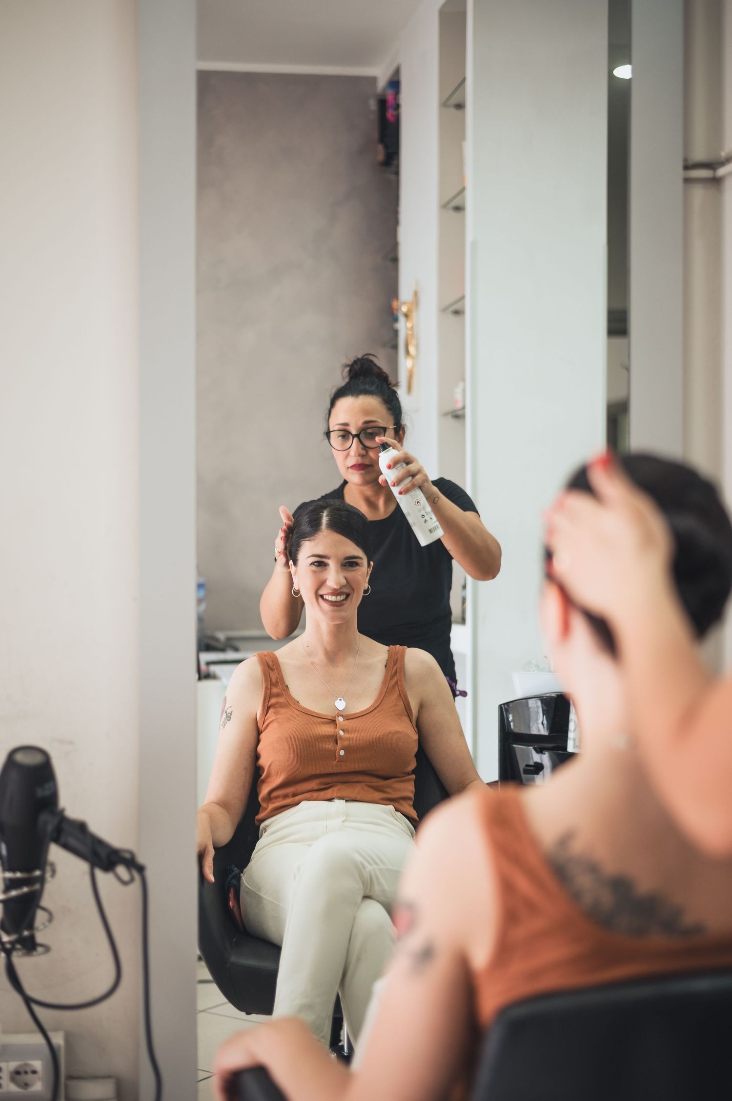 A salon scene showing hair styling preparation in progress.