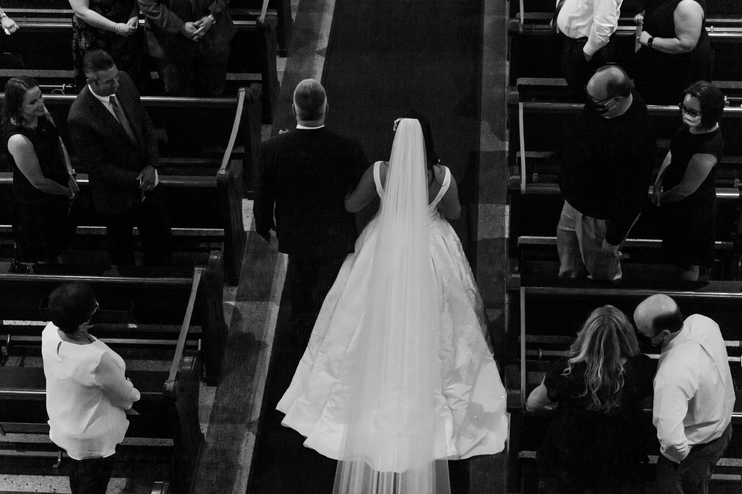 Black and white photo of wedding ceremony proceedings in church sanctuary.
