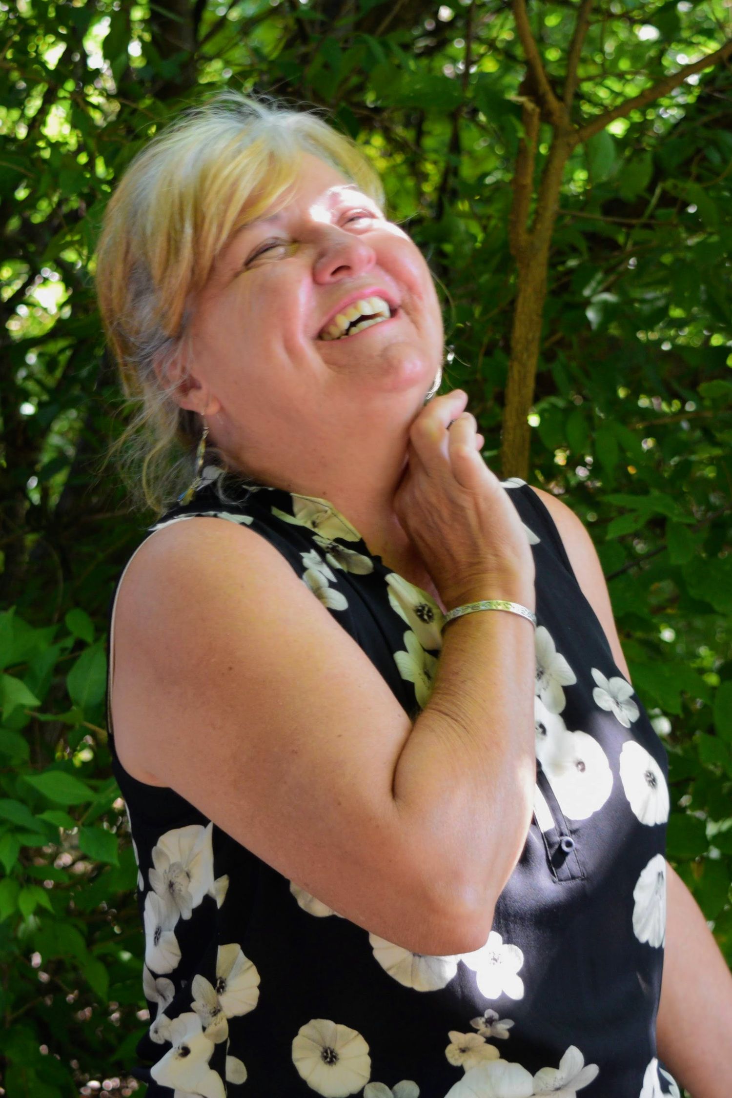 Headshot Portrait during Family Portrait Session. Overland Park, KS A middle-aged woman tosses her head back and laughs.